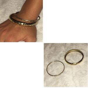 A bundle of 2 metal gold bracelets.